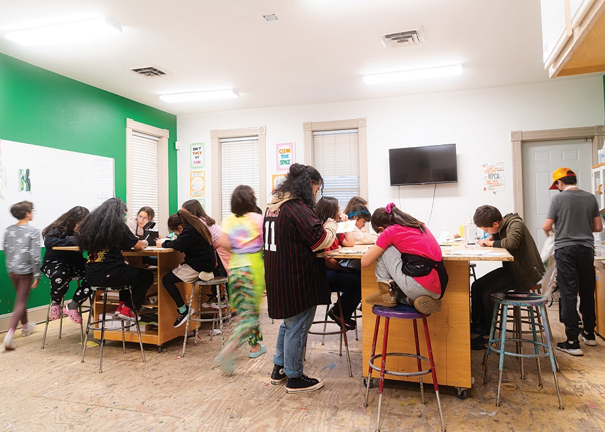 Students work on a painting project during After School Art Class led by Oscar Quinto-Zamudio (center), the Director of Arts Education at Walker’s Point Center for the Arts in Milwaukee on March 8, 2024. Photo by Brian Huynh