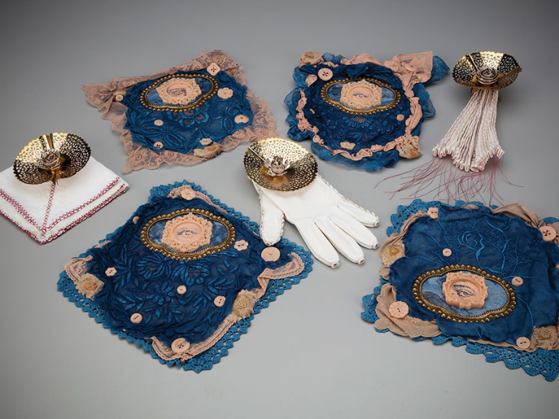 Marna Brauner and Hai Chi Jihn. Curio 4. 2024. Laser-etched paper, foundation makeup, cast wax buttons and frames, metals, dyed antique textiles, cloth objects, notions. 2 inches H x 30 inches W x 20 inches. Marna Brauner and Hai Chi Jihn. Curio 4. 2024. Laser-etched paper, foundation makeup, cast wax buttons and frames, metals, dyed antique textiles, cloth objects, notions. 2 inches H x 30 inches W x 20 inches.