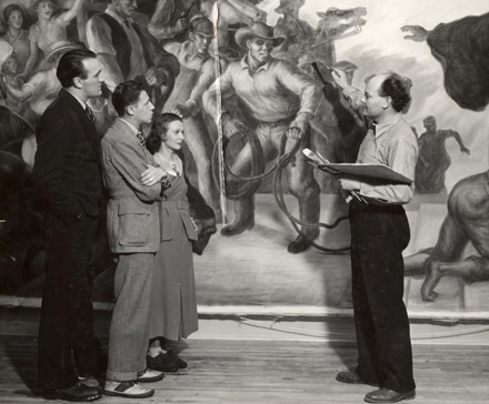 Univeristy of Wisconsin faculty and artist in residence John Steuart Curry (right) speaks with three onlookers about the mural he's at work on. UW Digital Collections/ID S10117