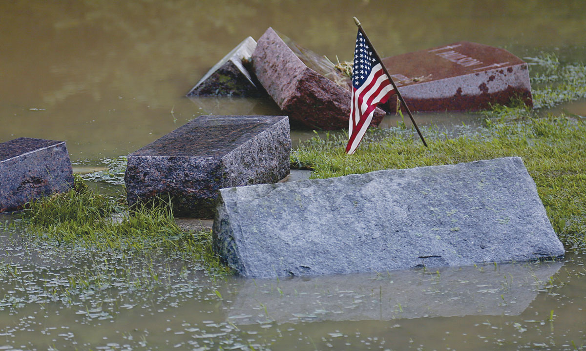 Massive tombstones in Skogdalen Cemetery, some weighing over 1,000 pounds, toppled like dominoes during the flooding. Photo by Jon Lee.