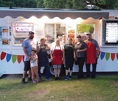 Family standing outside a food truck