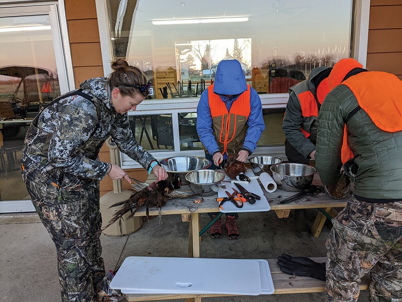 Hunt for Food students clean their harvest at the Beaver Dam Conservationists facility in Dodge County.