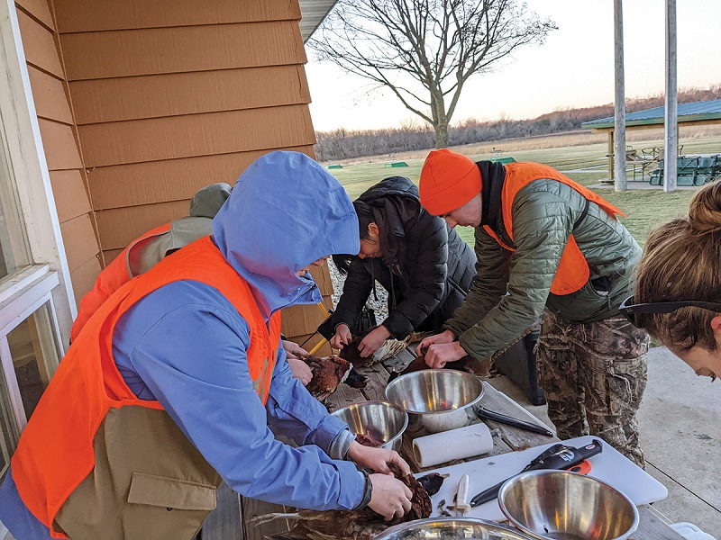 Hunt for Food students clean their harvest at the Beaver Dam Conservationists facility in Dodge County.