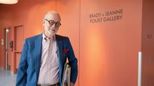 Photo of James Brady Foust in front of the sign for an art gallery he and his wife support