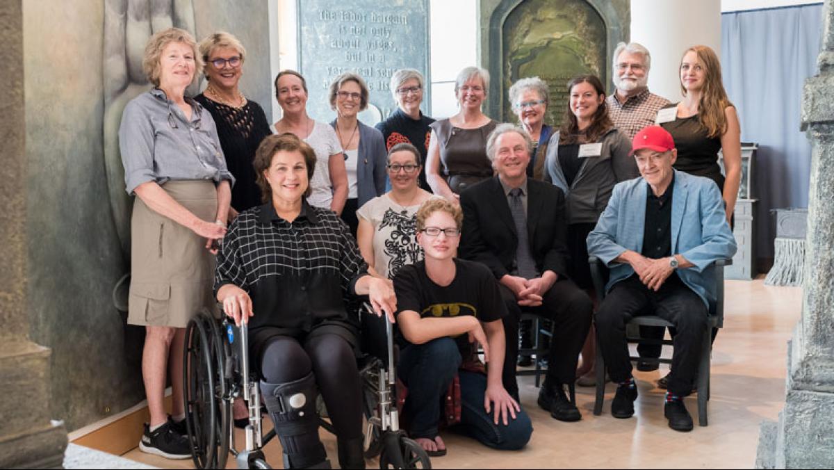 Artist Terese Agnew (in wheelchair after an art-related accident) and her collaborators for the epic Writing in Stone installation. Photo by Studio Indigo Photography.