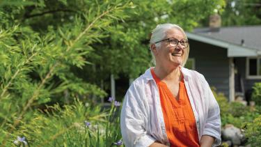 Amy Yocum sitting in her garden. Photo by Beth Skogen
